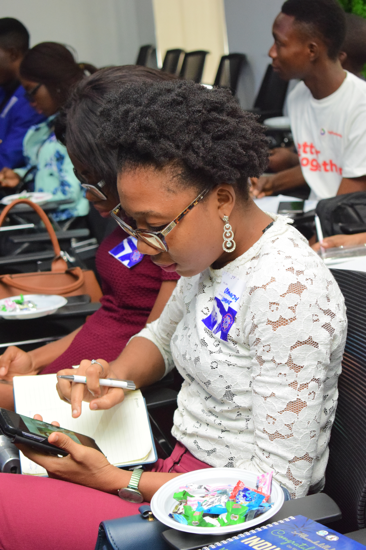 A participant taking notes during a digital skills and entrepreneurship training session