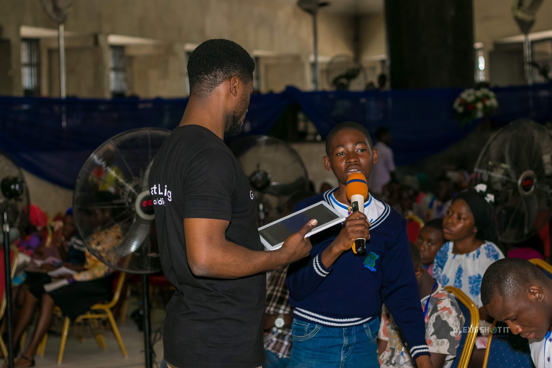 A secondary school student answering a digital literacy question during a community outreach session